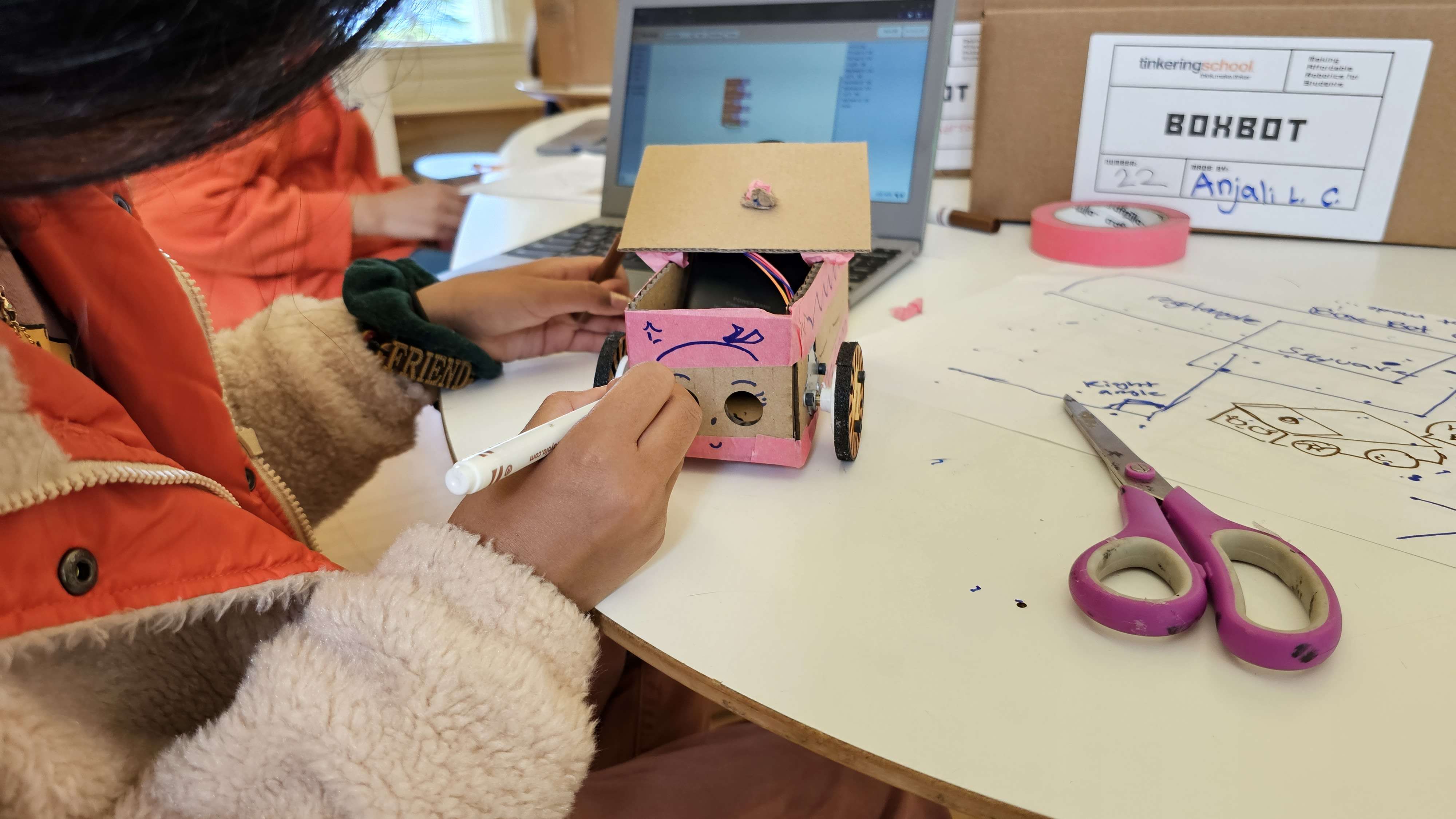 The Boxbot, a cardboard robot that is infinitely customizeable. One of the design criteria was that we had to feel OK hot-glueing a popcicle stick to it.